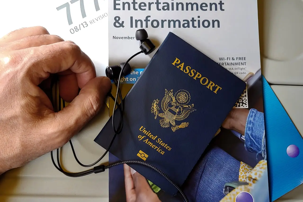 Mastering the First Impression: Your intriguing post title goes here Close-up of US passport with inflight magazine and headphones on an airplane seat, ready for travel.